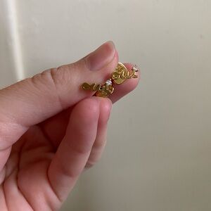 Kate Spade “Oui” pair of gold post earrings with spade shaped backs.